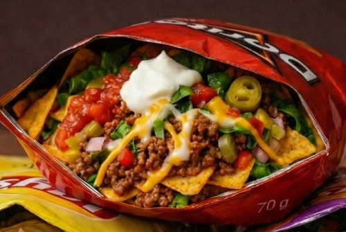 Three open bags of loaded nachos with various toppings on a wooden surface.